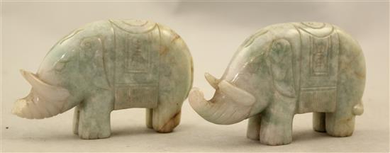 A pair of Chinese spinach green jade lion-dogs and a pair of jadeite figures of elephants, 20th century, 9.5cm, one wood stand